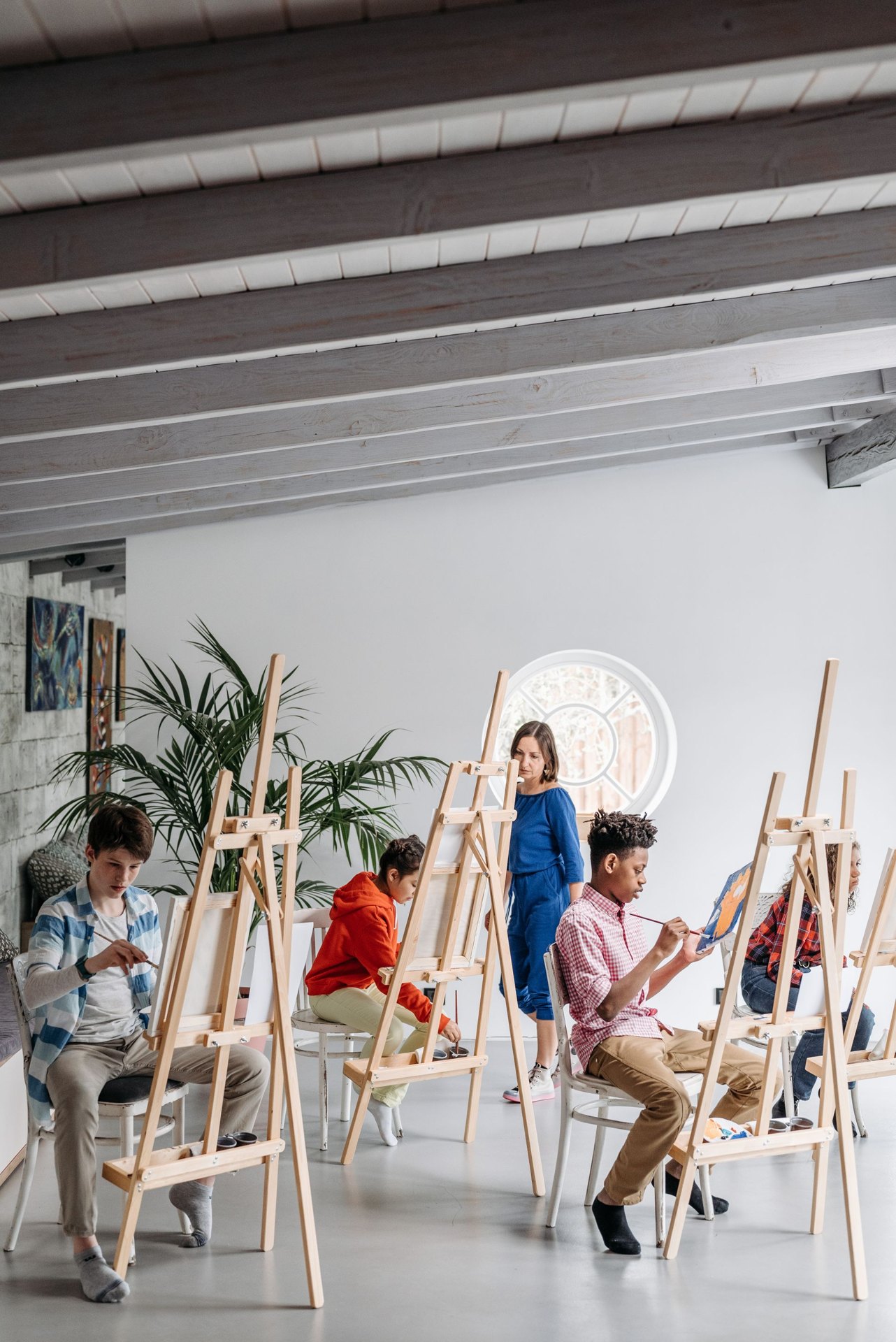Young artists working with paint in a bright classroom