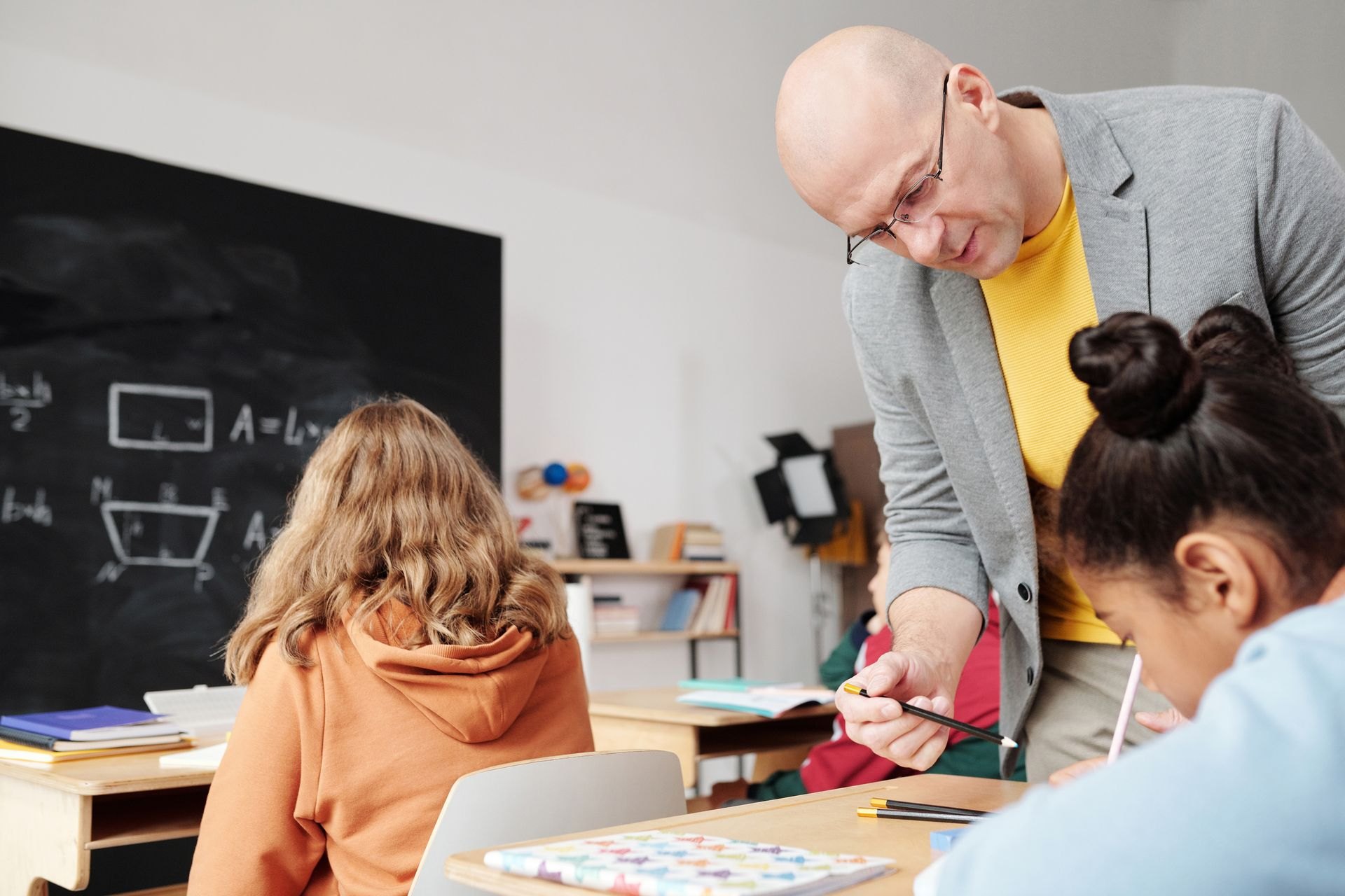 Teacher supporting students during classroom work